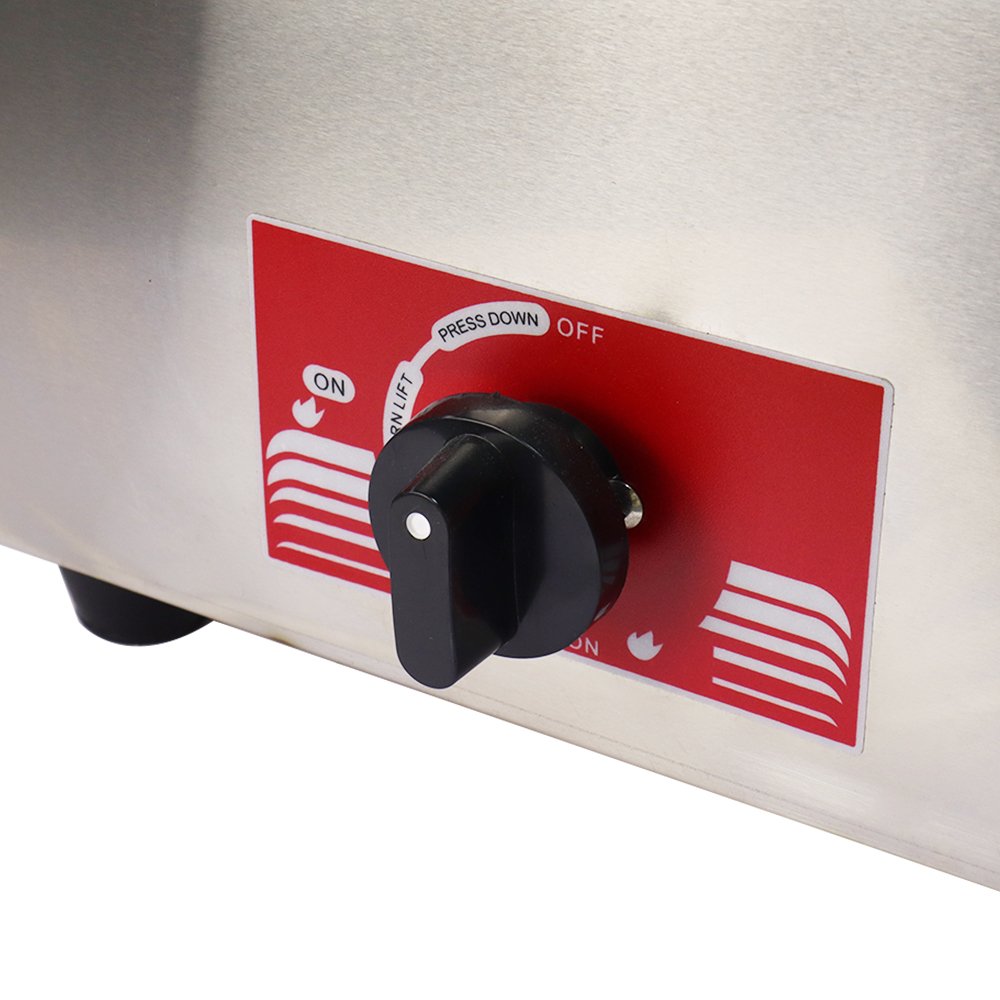 Close-up view of push-to-turn gas control knob with flame level settings and safety lock