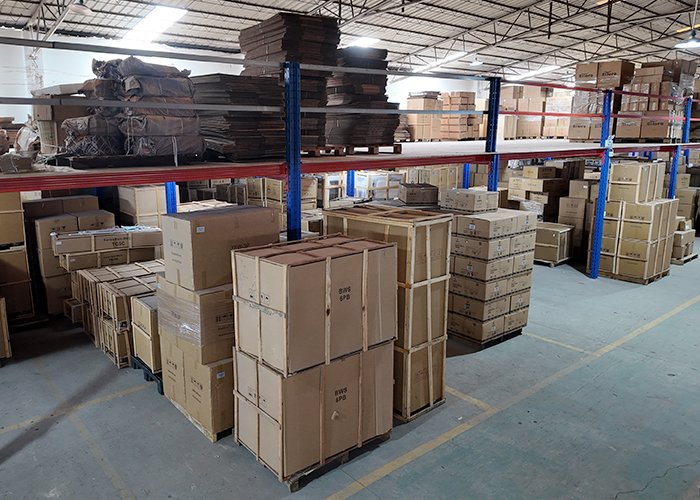 Packaged commercial kitchen equipment and export crates stored in the Tarzan Kitchen factory warehouse