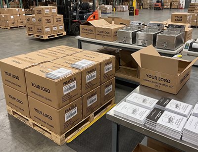 Private-label commercial kitchen equipment packed in custom-branded export cartons at the Tarzan Kitchen warehouse